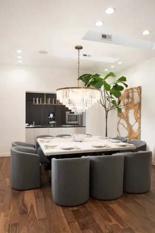 a room with water heater and wooden cabinets
