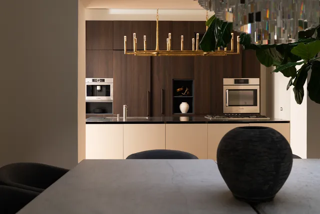 a bedroom with a bed table and a potted plant