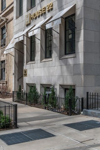 a living room with furniture a potted plant and a fireplace