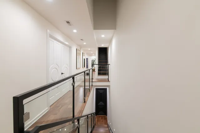 a view of staircase with wooden floor and white walls