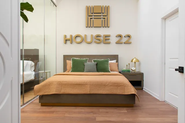 a bedroom with a sink and a mirror