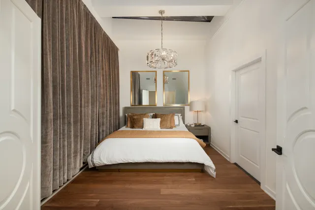 a bedroom with two beds and a chair