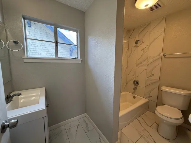a bathroom with a toilet sink and shower