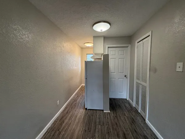 a view of hallway with wooden floor