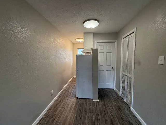 a view of hallway with wooden floor