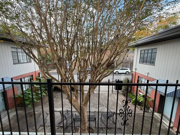 a view of a house with large trees