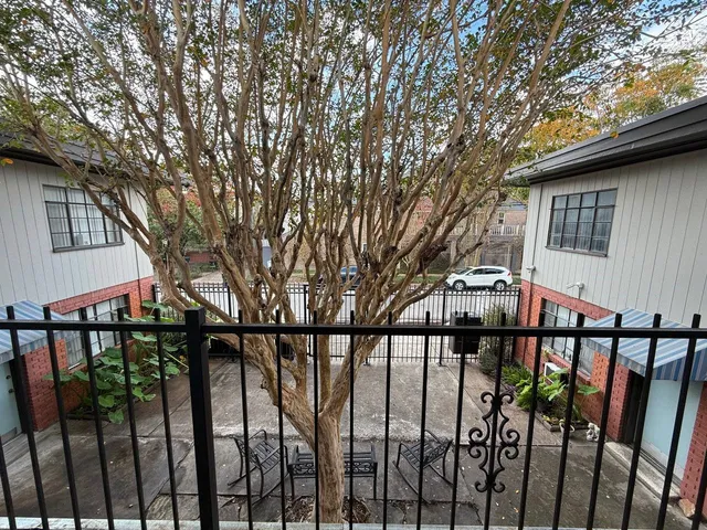 a view of a house with large trees