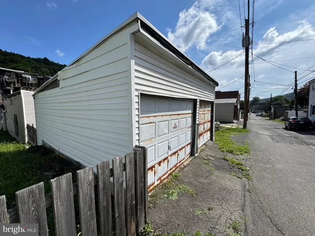 a view of a house with a yard and wooden fence