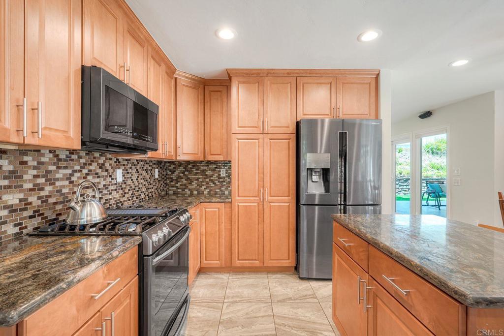 13639 Freeport Road San Diego, CA 92129 - Photo 16 of 44 a kitchen with stainless steel appliances granite countertop a refrigerator stove and microwave