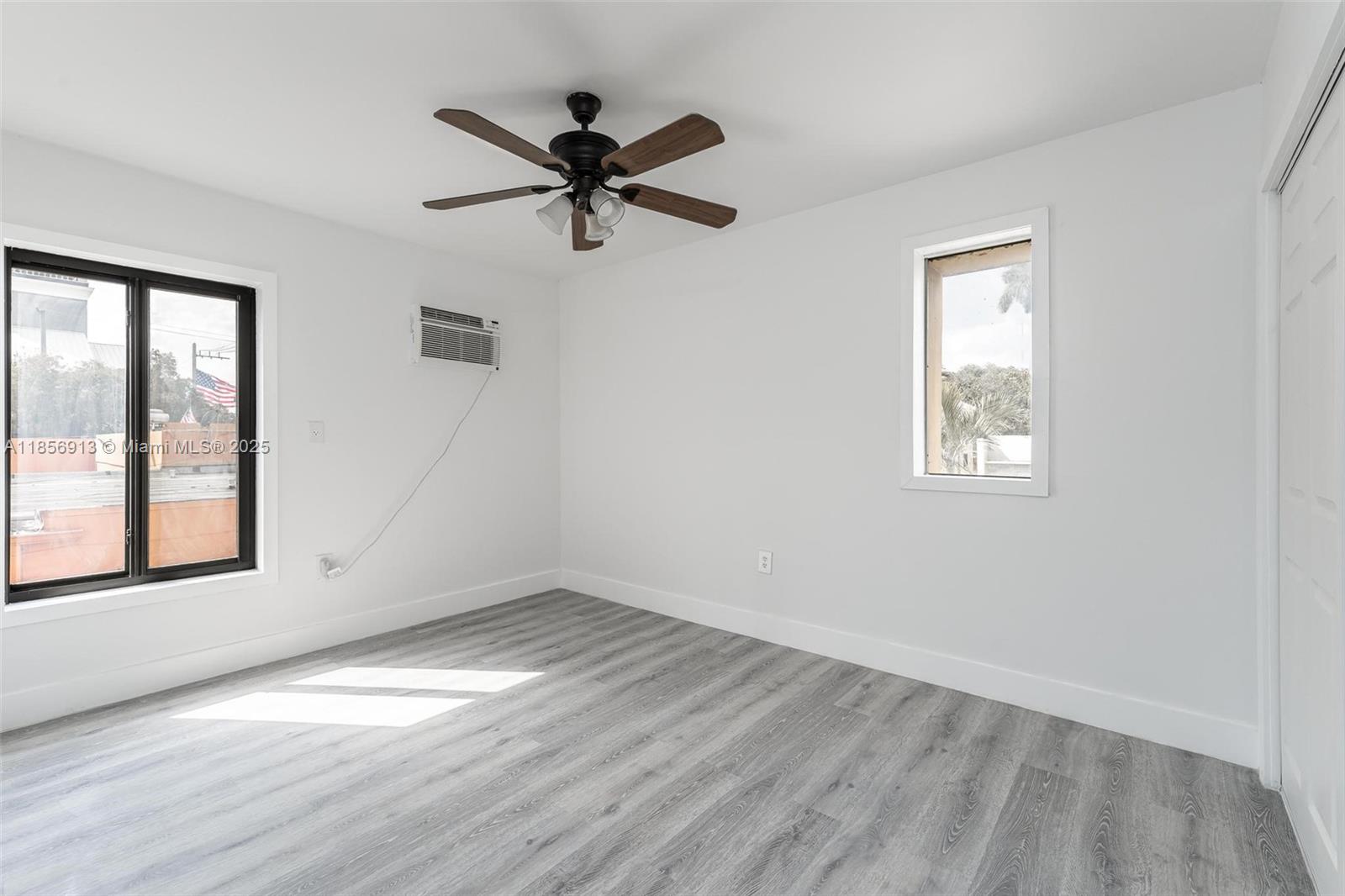 852 Southwest 1st Street, Unit 4 Miami, FL 33130 - Photo 11 of 17 a view of empty room with wooden floor and fan