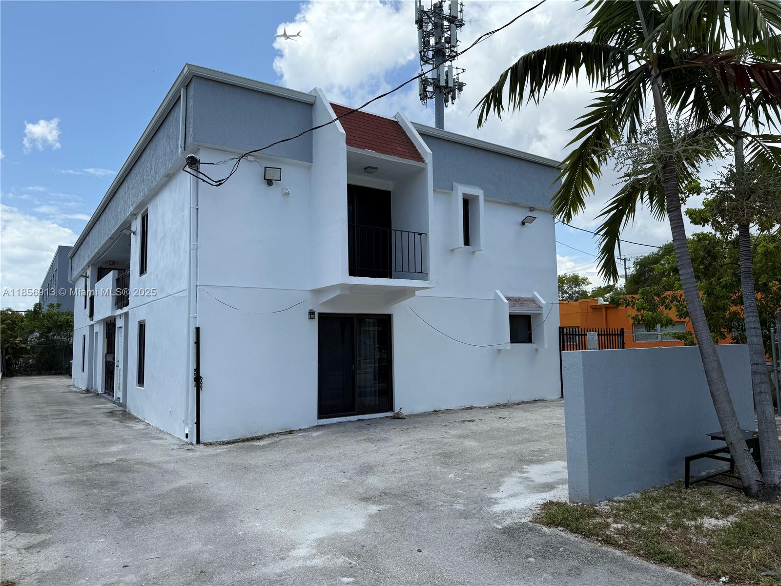 852 Southwest 1st Street, Unit 4 Miami, FL 33130 - Photo 14 of 17 a view of a white house with a potted plant and a large window