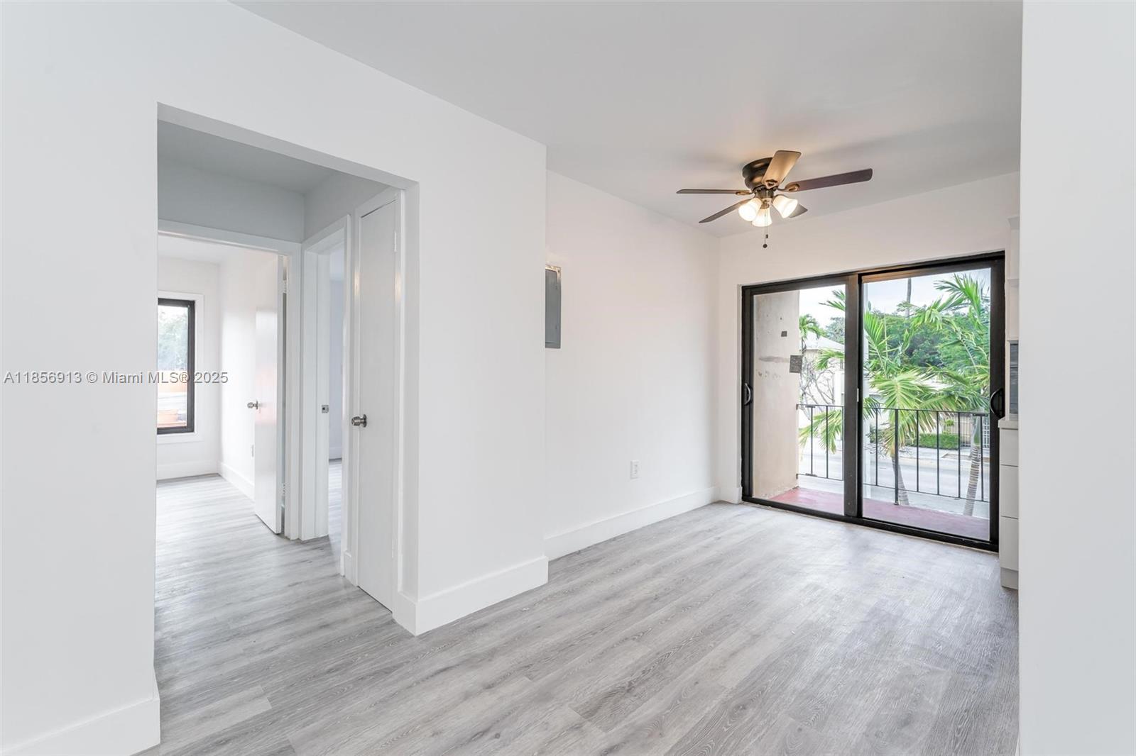 852 Southwest 1st Street, Unit 4 Miami, FL 33130 - Photo 6 of 17 a view of empty room with wooden floor and fan