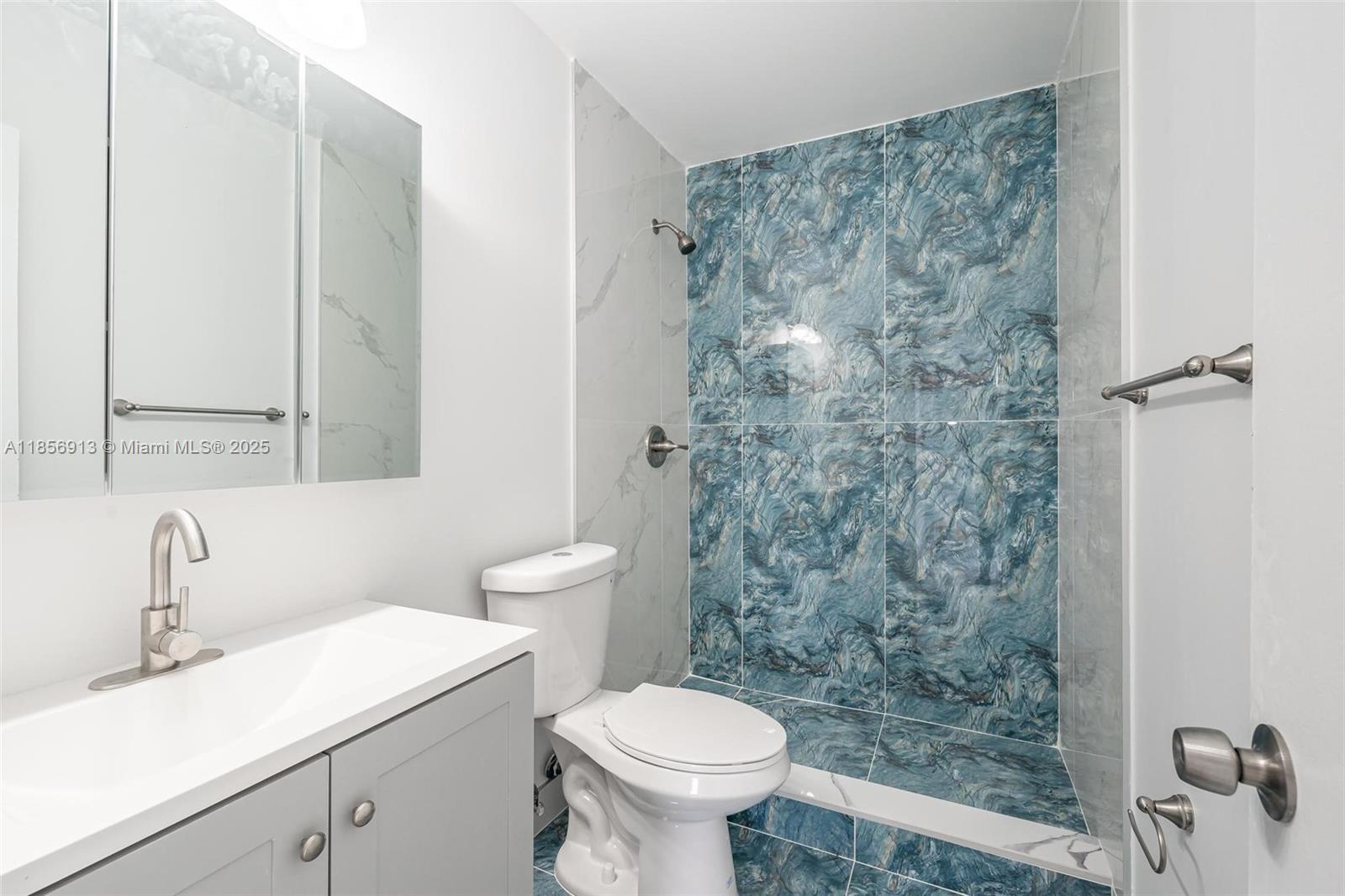 852 Southwest 1st Street, Unit 4 Miami, FL 33130 - Photo 10 of 17 a bathroom with a sink toilet and a mirror
