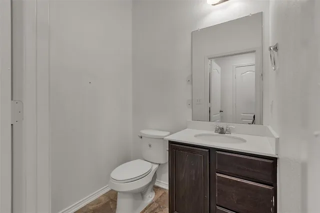 a bathroom with a sink toilet and vanity