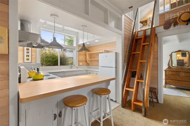 a kitchen with furniture a sink and a window
