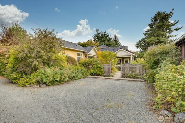 a view of a house with a yard and garage