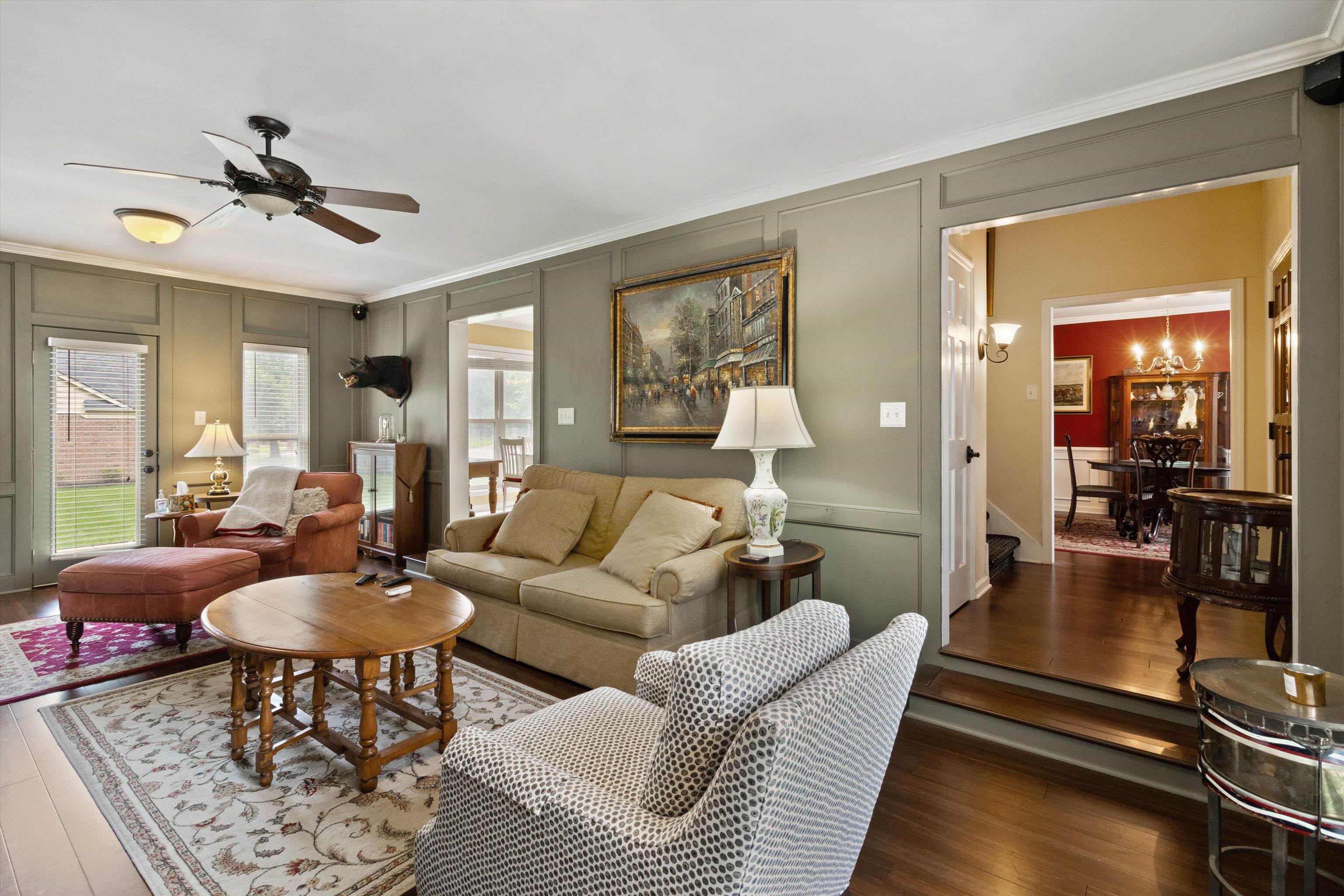 2010 Newfields Road Germantown, TN 38139 - Photo 8 of 28 Living area with a decorative wall, ornamental molding, wood finished floors, a ceiling fan, and a chandelier