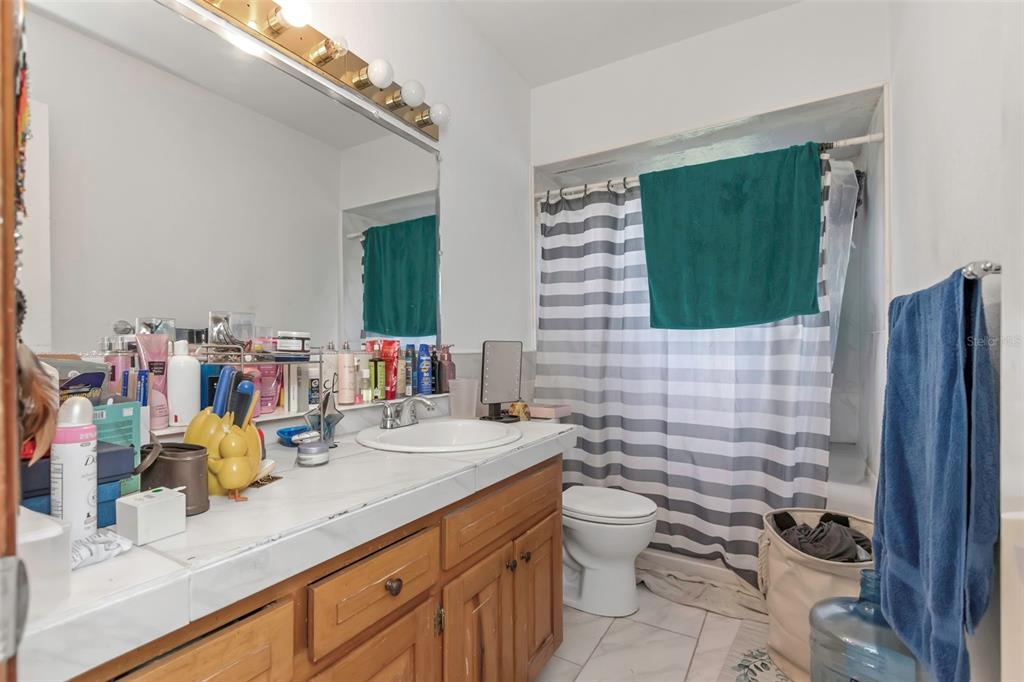 17500 Marsh Road Lutz, FL 33558 - Photo 17 of 80 a bathroom with a granite countertop sink mirror and toilet