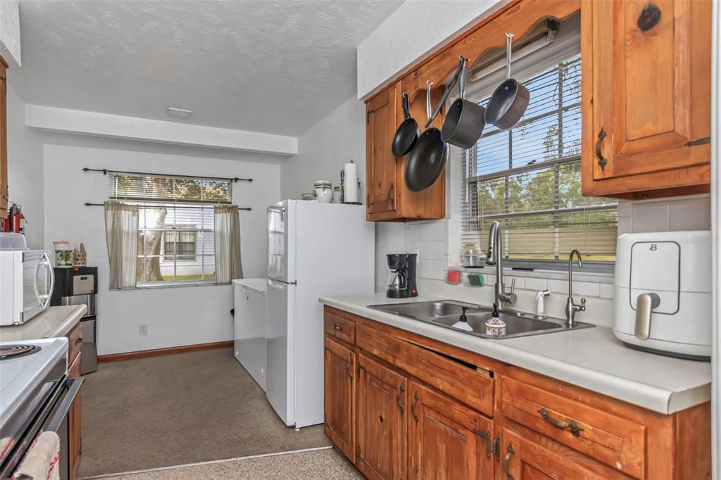 17500 Marsh Road Lutz, FL 33558 - Photo 22 of 80 a kitchen with stainless steel appliances granite countertop a refrigerator and a stove