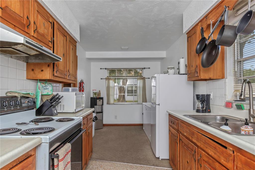 17500 Marsh Road Lutz, FL 33558 - Photo 24 of 80 a kitchen with stainless steel appliances granite countertop a sink stove and refrigerator