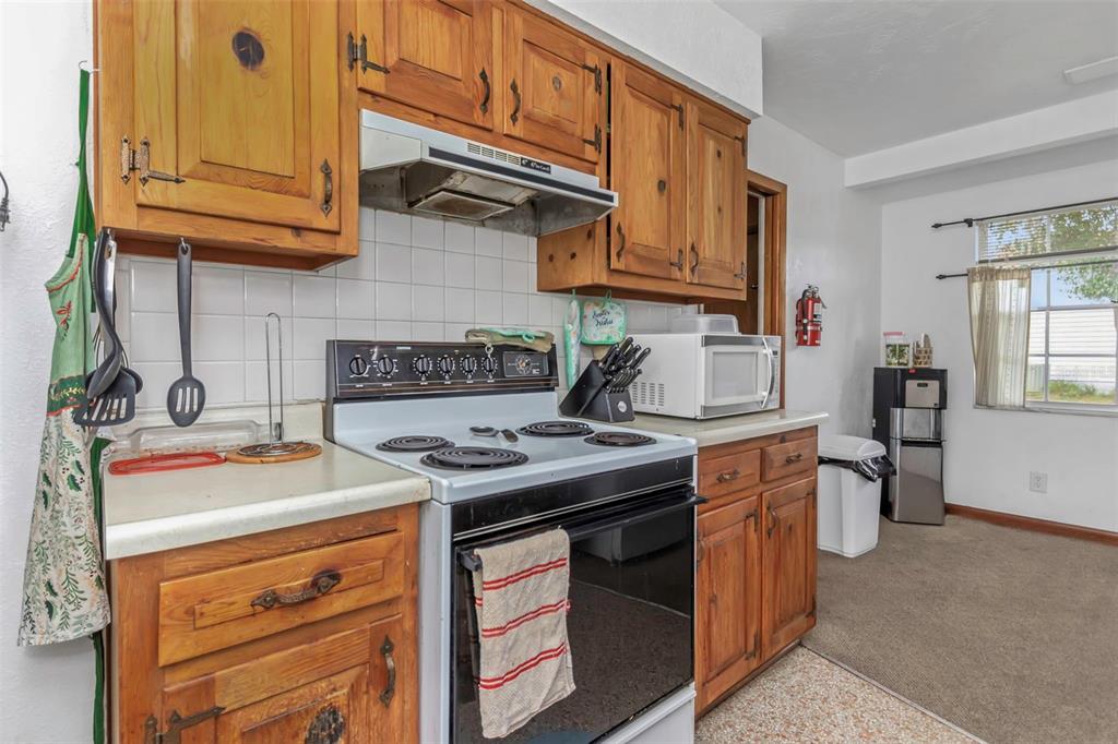 17500 Marsh Road Lutz, FL 33558 - Photo 25 of 80 a kitchen with stainless steel appliances granite countertop a sink stove and cabinets