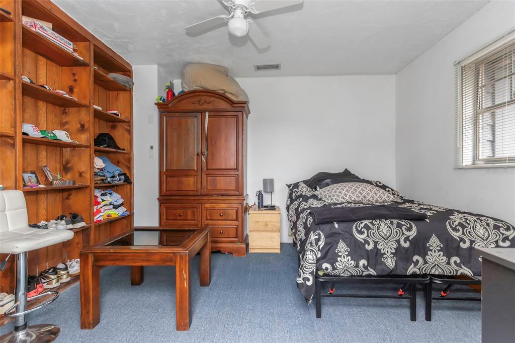 17500 Marsh Road Lutz, FL 33558 - Photo 26 of 80 a bedroom with a bed and a cabinet