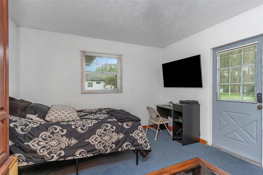 17500 Marsh Road Lutz, FL 33558 - Photo 29 of 80 a bedroom with a bed and a flat screen tv