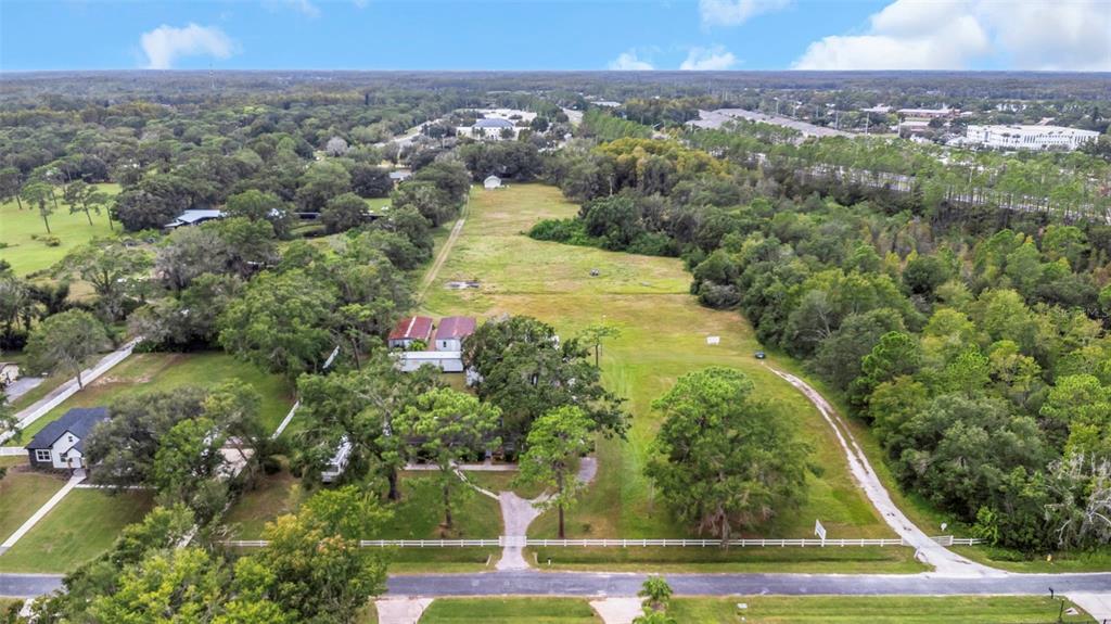 17500 Marsh Road Lutz, FL 33558 - Photo 3 of 80 an aerial view of a residential houses with outdoor space and trees