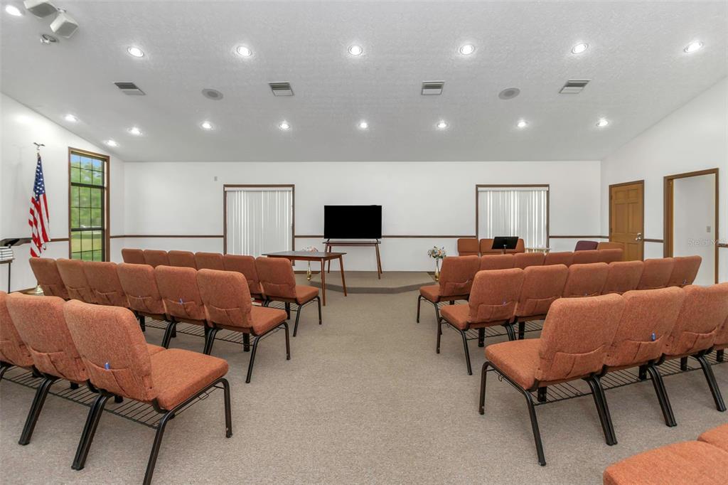 17500 Marsh Road Lutz, FL 33558 - Photo 44 of 80 a living room with furniture a flat screen tv and a couch