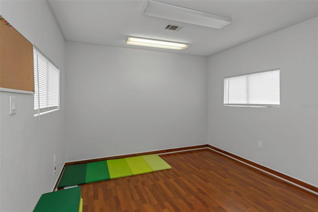 17500 Marsh Road Lutz, FL 33558 - Photo 54 of 80 a room with a wooden floor and small window