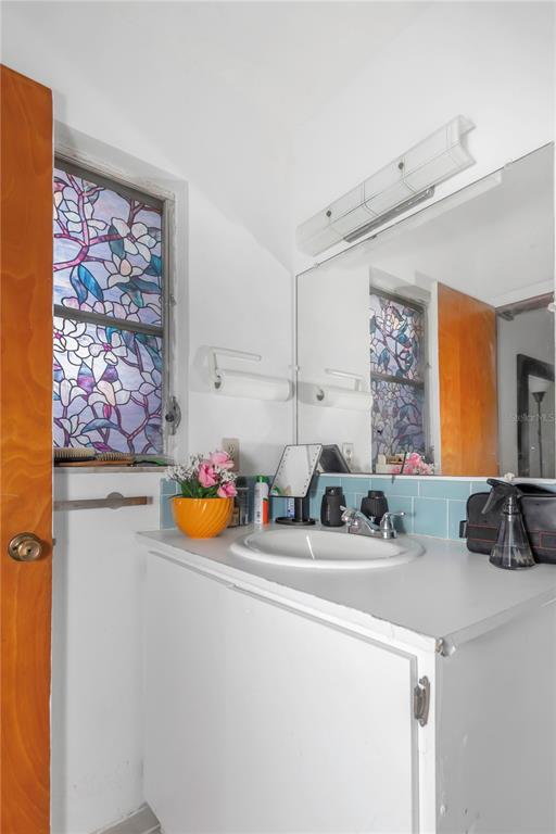 17500 Marsh Road Lutz, FL 33558 - Photo 62 of 80 a bathroom with a sink mirror and window