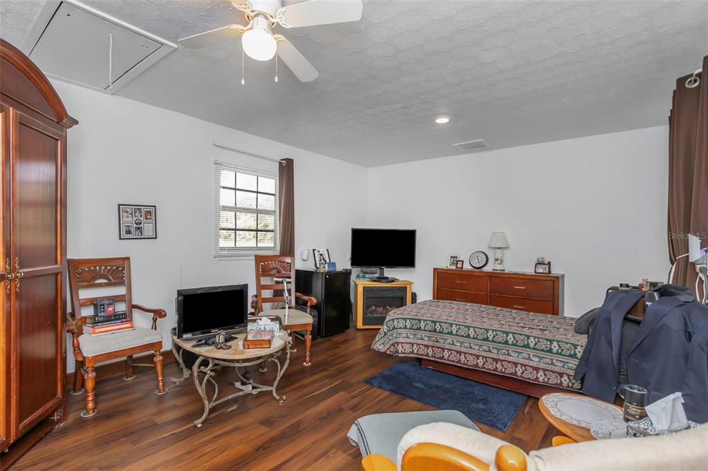 17500 Marsh Road Lutz, FL 33558 - Photo 8 of 80 a living room with furniture a fireplace and a flat screen tv