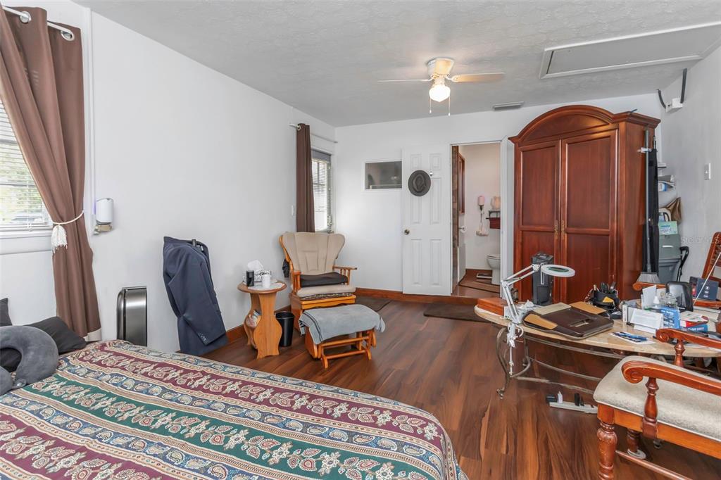 17500 Marsh Road Lutz, FL 33558 - Photo 9 of 80 a bedroom with furniture and a wooden floor