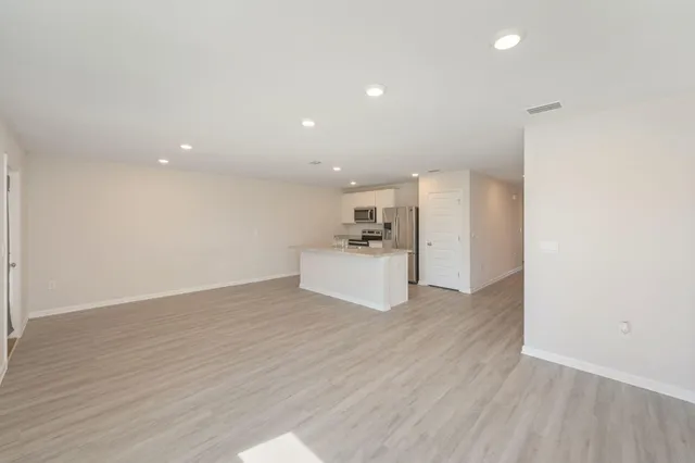 a view of a kitchen with a sink and a refrigerator