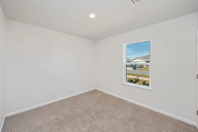 an empty room with windows and closet