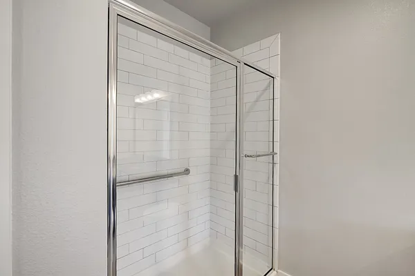 a bathroom with a glass shower door