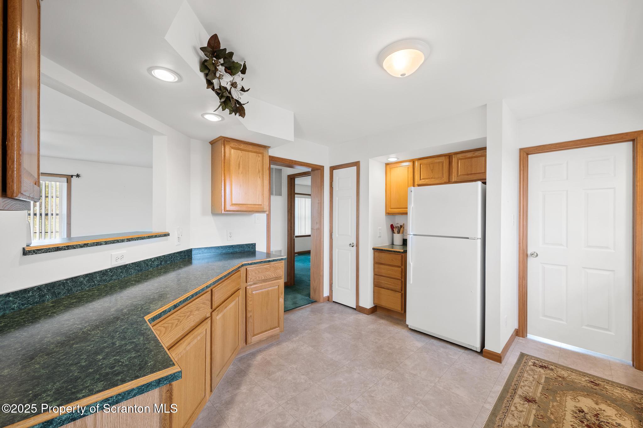 1336 Bush Road Montrose, PA 18801 - Photo 11 of 55 a large kitchen with a refrigerator a sink and dishwasher