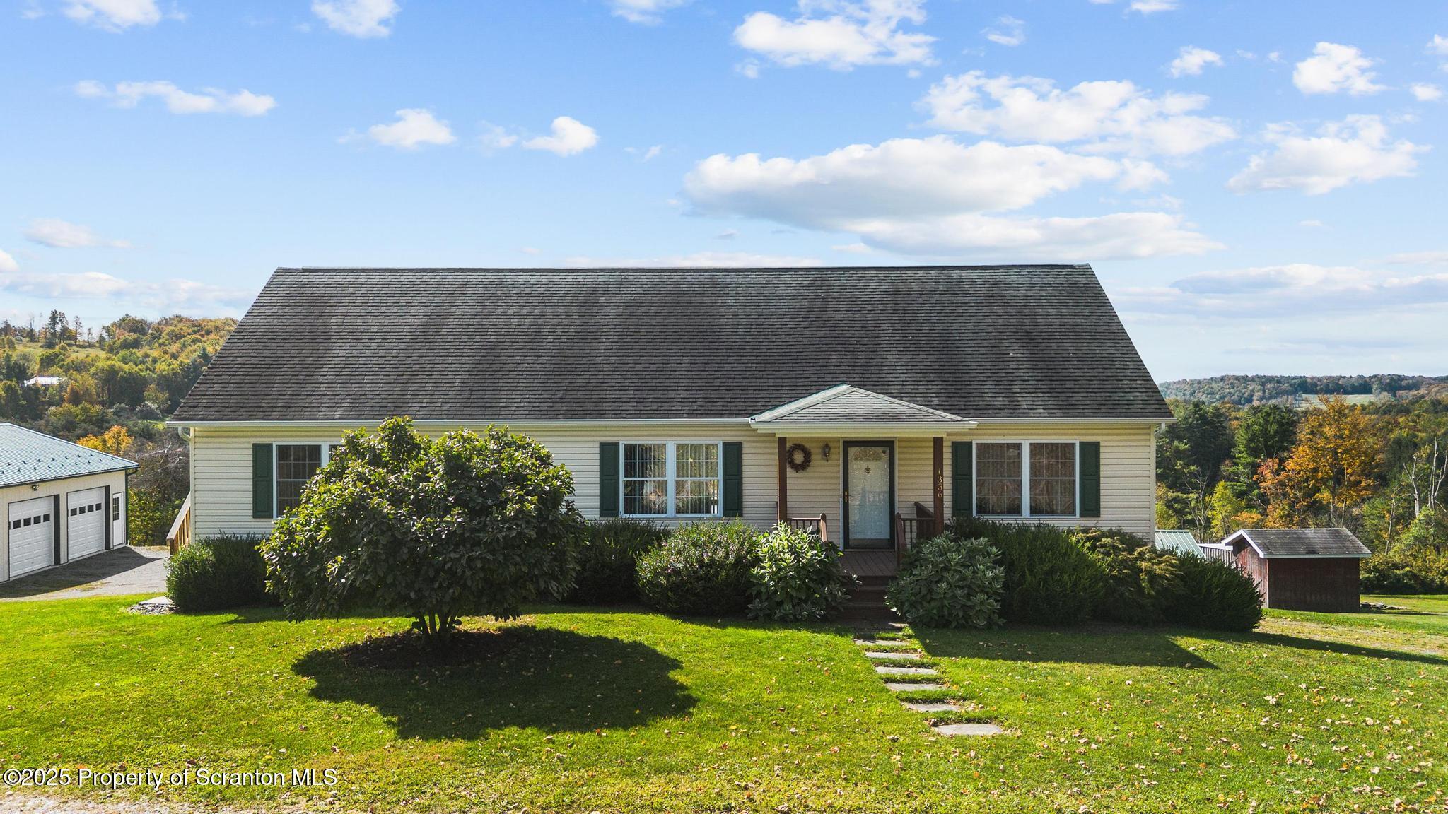 1336 Bush Road Montrose, PA 18801 - Photo 2 of 55 a front view of a house with a yard
