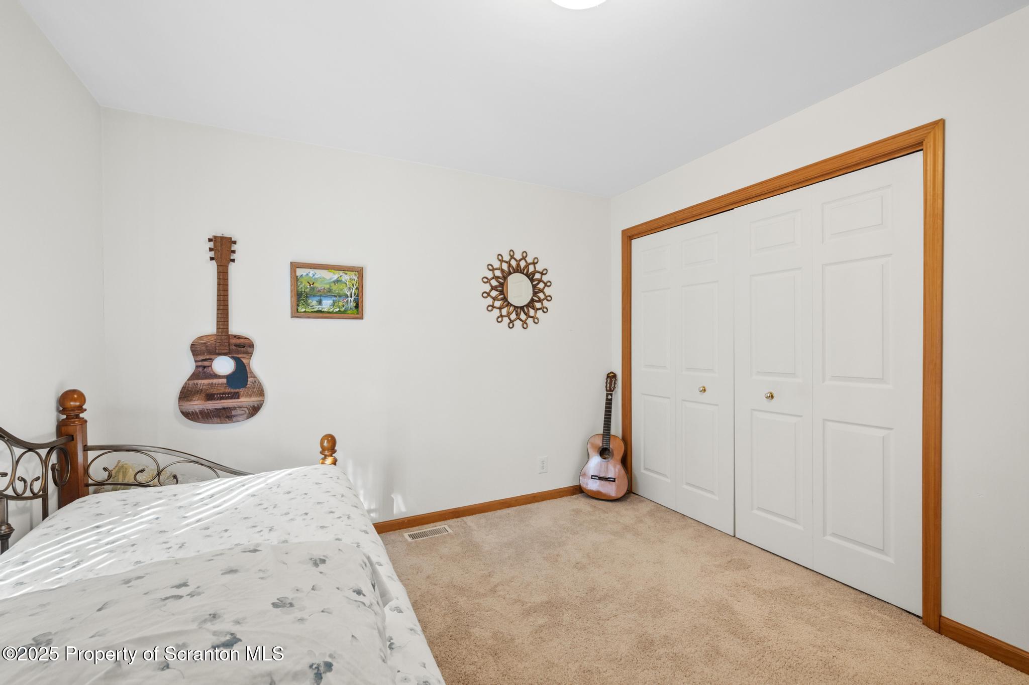 1336 Bush Road Montrose, PA 18801 - Photo 22 of 55 a bedroom with a bed and a painting on the wall