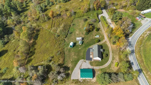 an aerial view of a house with swimming pool and mountain view