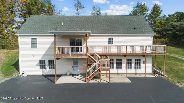 a view of balcony with two chairs and a wooden deck