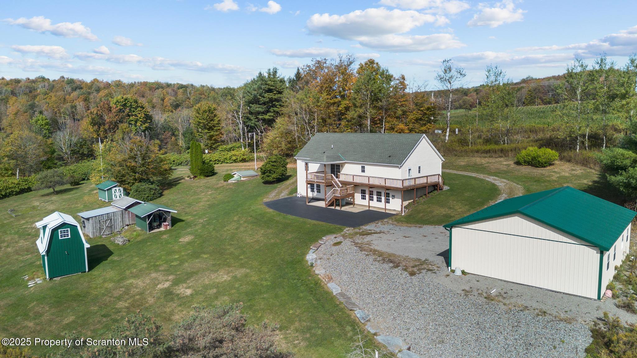 1336 Bush Road Montrose, PA 18801 - Photo 9 of 55 a view of a garden with a building in the background