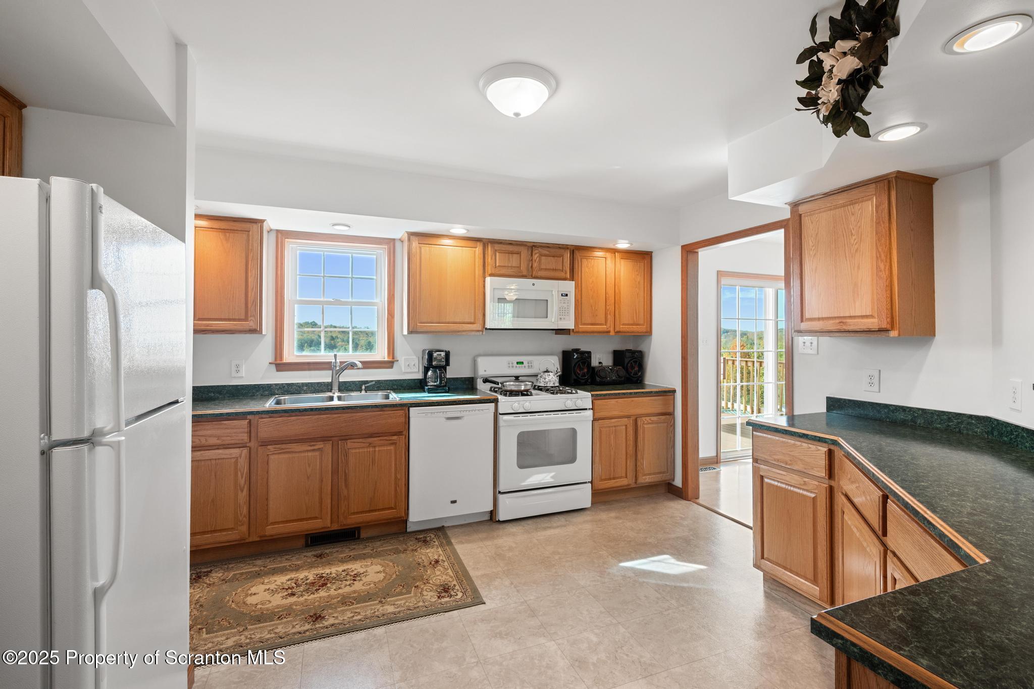 1336 Bush Road Montrose, PA 18801 - Photo 10 of 55 a kitchen with a refrigerator stove top oven and sink