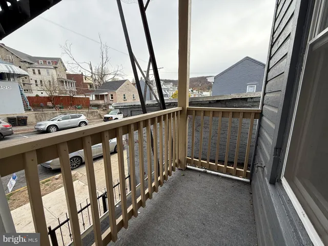 a view of balcony with wooden floor and fence