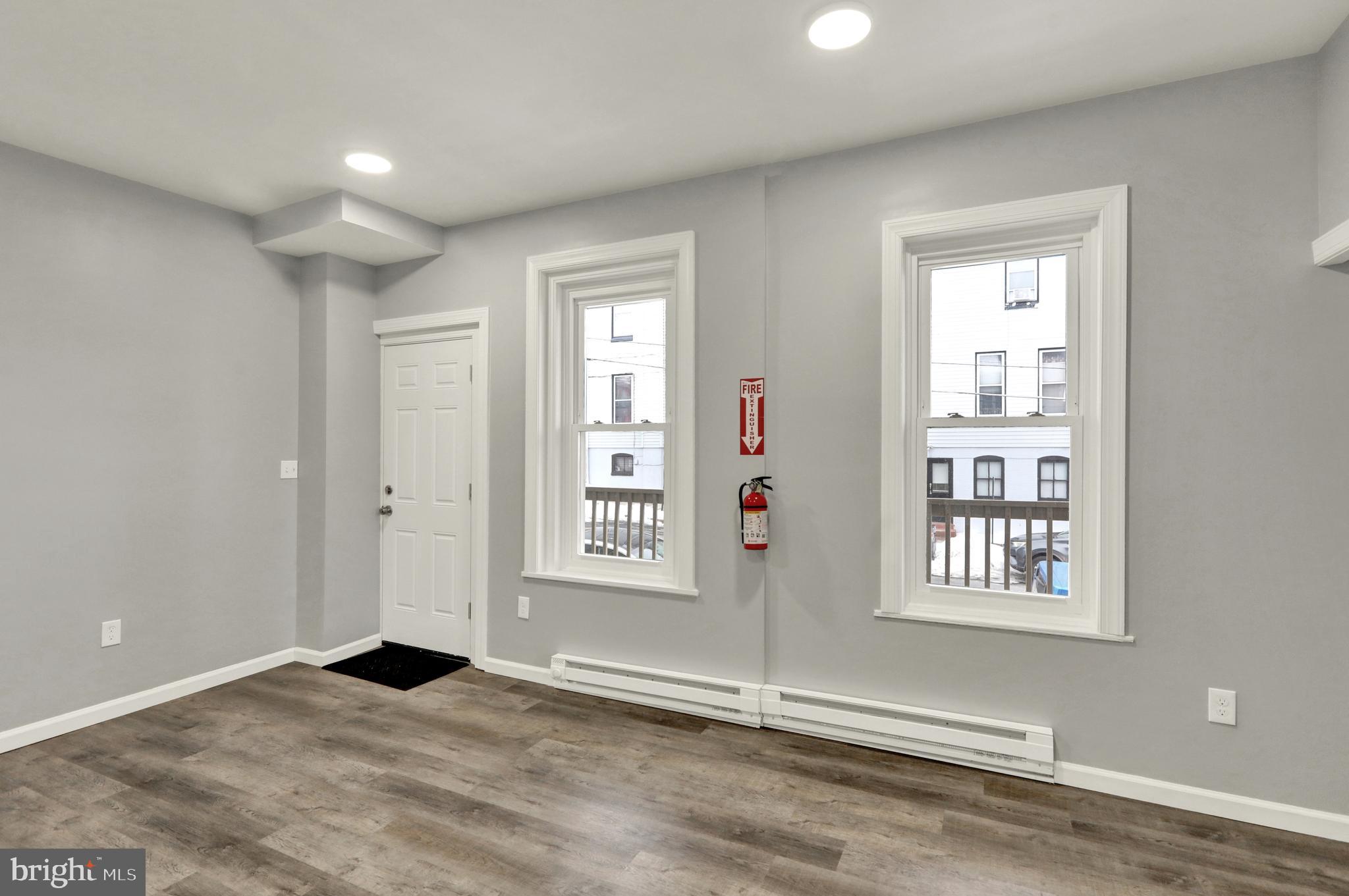1156 Franklin Street, Unit 2 Reading, PA 19602 - Photo 3 of 7 an empty room with windows and closet