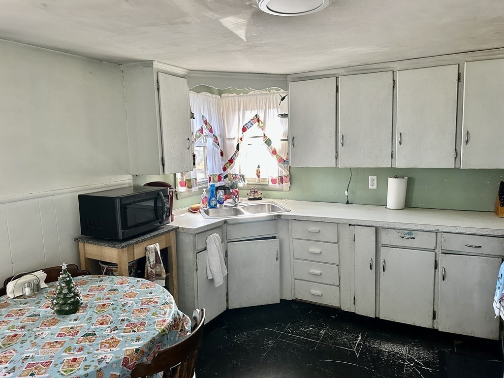 97 Hillcrest Road Waltham, MA 02451 - Photo 3 of 14 a kitchen with a sink cabinets and chair