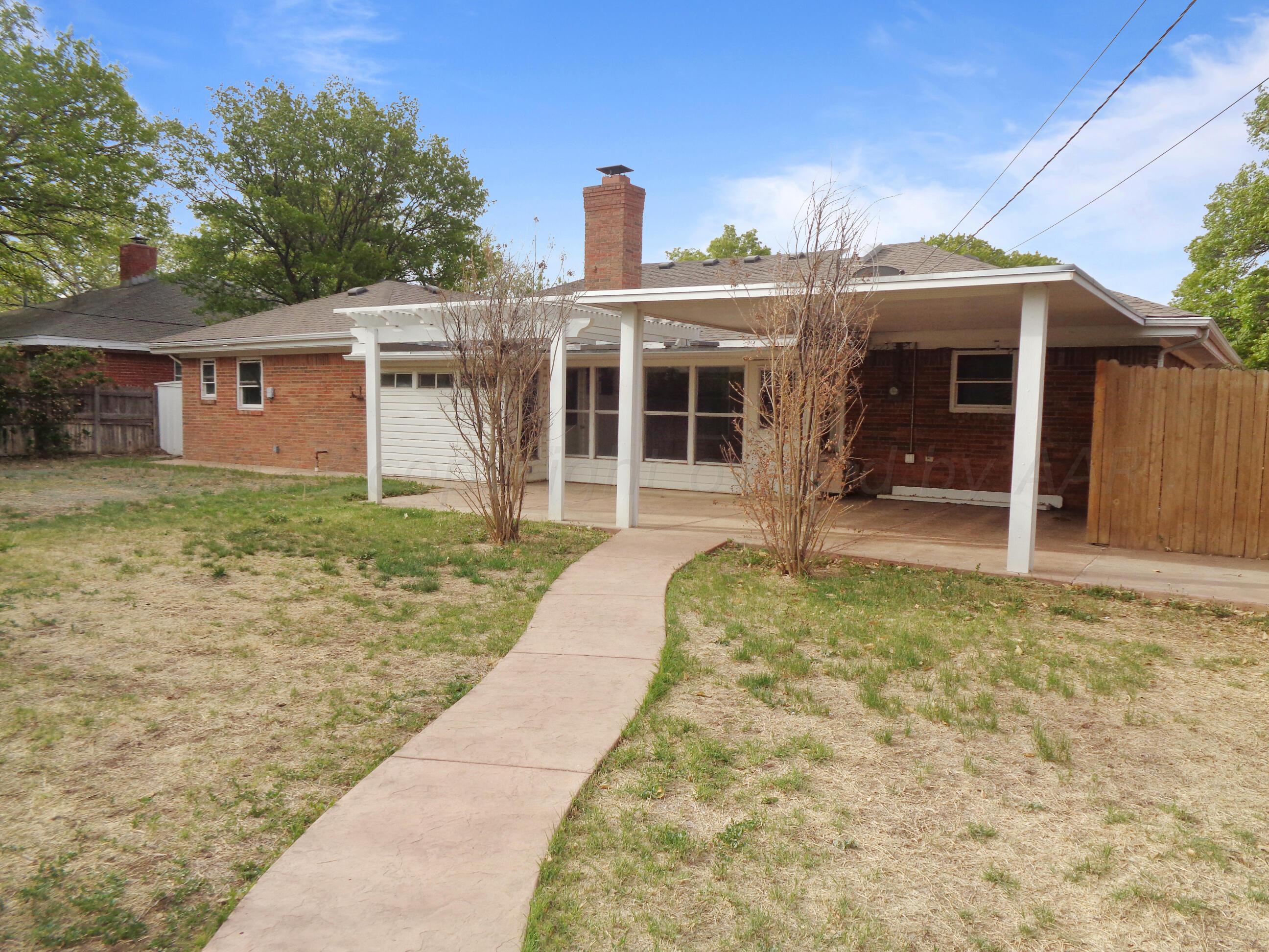 7108 Elmhurst Road Amarillo, TX 79106 - Photo 8 of 26 a front view of a house with a yard