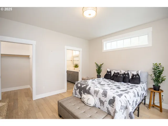 a bedroom with a bed and a potted plant