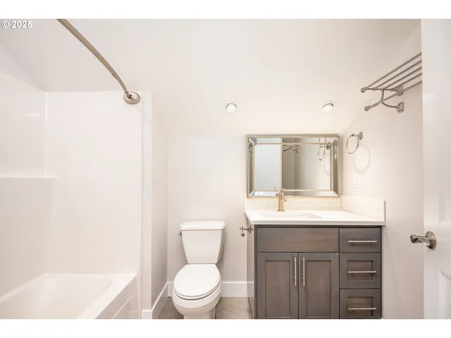 a bathroom with a sink toilet vanity and shower