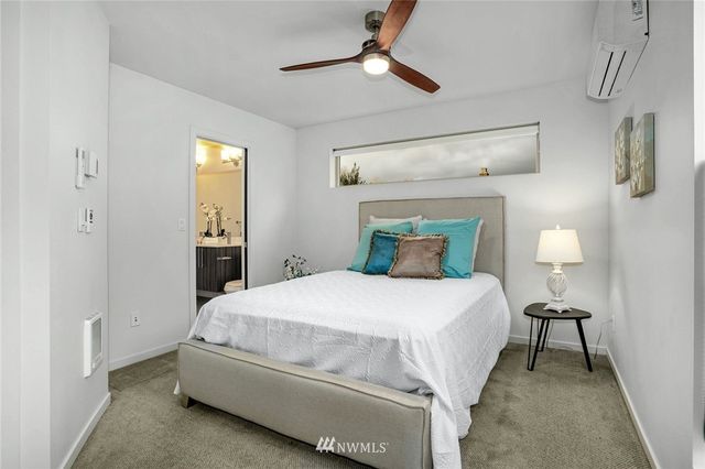 a bedroom with a bed and a lamp